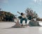 Active skateboarder jumping and performing a trick in a ramp of a skate park