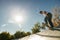 Active skateboarder jumping and performing a trick in a ramp of a skate park