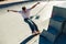 Active skateboarder jumping and performing a trick in a ramp of a skate park