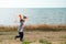 Active small kid running with colorful kite in his hand on sea shore background outdoor leisure games