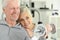 Active smiling senior couple exercising in gym