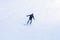 Active snowboarder jumping in mountains on a sunny day