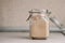 Active sourdough rye sourdough in a rustic jar. Vertical orientation, front view