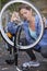 Active sport woman fixing broken bicycle in forest