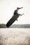 active sportsman jumps spectacularly on wakeboard above the water with splashes
