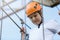 Active sporty kid in helmet doing activity in adventure park with all climbing equipment. Active children climb on the trees