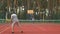 Active sporty men playing tennis game on hardcourt