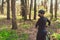 Active sporty woman riding mountain bike on forest trail, wearing a face mask against air pollution and covid19 coronavirus.