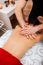 Active strong man working in massage cabinet with dark-haired client