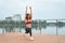 Active strong woman doing fitness exercises on wooden pier