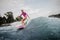 Active teenager girl standing on the orange wakeboard