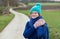 Active thirty year old woman in winter clothes, bonnet and scarf posing on a walking trail in Hageland