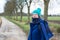 Active thirty year old woman in winter clothes, bonnet and scarf posing on a walking trail in Hageland