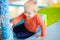 Active toddler boy playing at indoors playground