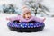 Active toddler girl sliding down the hill on snow tube. Cute little happy child having fun outdoors in winter on sledge