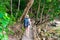 Active tourist in a hike on a wooden trail