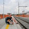 Active tourist and his dog at railway station. Backpacker and beagle dog waiting on railway station. Older tourist