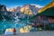 Active tourist on the shore of lake Braies, Dolomites, Italy
