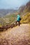 Active vacation tourism. Man enjoying impressive mountainscape. Arid canyon valley extend far below. Santo Antao, Cabo