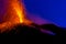 Active volcano spraying lava into the night