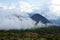 Active volcano Yzalco covered in the clouds