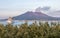 Active Vulcan Sakurajima and Kagoshima Ferry arriving the Port during summer sunset. Located in Kagoshima, Kyushu, South of Japan