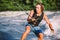 Active wakesurfer jumping on wake board down the river waves. Surfer on wave. Male athlete training on wakesurf training