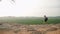 Active woman with backpack hikes up mountain trail, panoramic landscape of Sigiriya Rock behind. Explorer treks on rocky