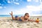 Active woman in beachwear on seacoast with sun block laying