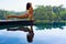 Active woman in bikini stretching at poolside to keep fit