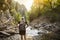 Active Woman hiking across a mountain stream on a hike