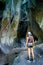 Active Woman Hiking through Scenic Dense Foggy Forest with Rock Canyon and Tree with Backpack on Running Trail.