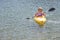 Active Woman Kayaking on Beautiful Mountain Lake.