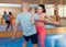 Active woman with professional trainer are training captures on the self-defense course in gym