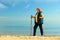 Active woman senior nordic walking on a beach