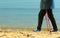 Active woman senior nordic walking on a beach. legs