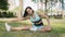 Active Woman Stretching Leg in a Sunny Park