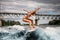 Active woman on surfboard energetically rides the wave