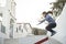 Active woman training jumping on village rural street with church in background