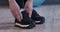 Active woman tying shoelaces before sport training