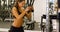 Active woman workout triceps muscles pulling cable machine in gym