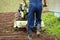 Active Worker With Tractor Plows Land On Agricultural Field In Spring Close Up