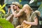 active young couple in safari suits with parrot hiking