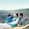 Active young happy family on picnic. small boy crying in the arms of their parents. In vintage colors