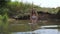 Active Young Slender Woman In White Bikini Begins To Swim In The Lake