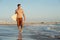 Active young surfer holding a surfboard