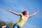 Active young woman jumping high in sunshine