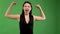 Actively aggressive young woman raising her arms up showing her biceps