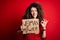 Activist with curly hair and piercing protesting holding poster with woman power message doing ok sign with fingers, excellent