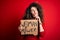 Activist with curly hair and piercing protesting holding poster with woman power message serious face thinking about question,